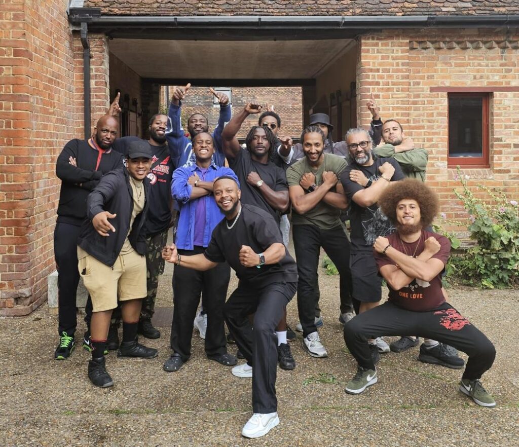Solomon Adams with participants on the final day of the Mandem's Quarters retreat, a healing space for Black and Brown men